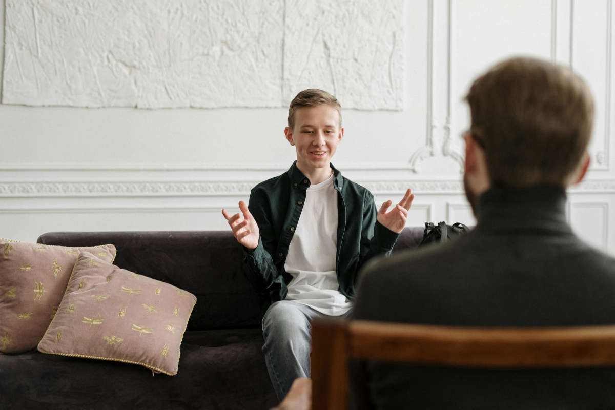 teen speaking with therapist at counseling session